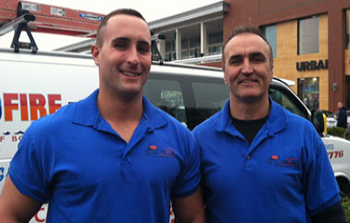 portfolio_4 two men in blue polo shirts standing next to each other